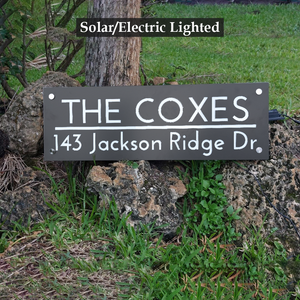 Radiant Solar-Powered Address Sign with Ground Stakes featuring a family name sign. A solar panel on top, LED lights, and ground stakes included.