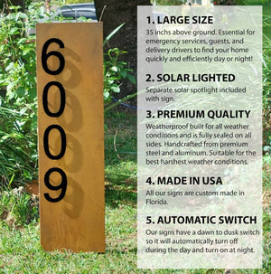 Rustic Double Sided 35-Inch Lighted Modern Steel Address Sign in Rusted Patina with Black Numbers option, illuminated at night with solar spotlight, designed for curb appeal and functionality. Unique rust patterns make each sign one-of-a-kind.