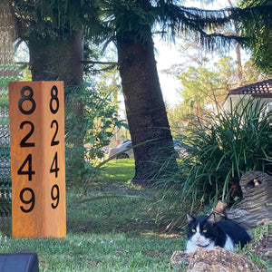 Image of our Double Sided 35-Inch Lighted Modern Steel Address Sign. A stunning steel address sign with custom rust patterns, high-performance solar spotlight, and magnetic numbers. Choose between Rusted Patina with Black Numbers or Black Sign with Silver Numbers. Enhance your home's curb appeal, day and night. Caution: Includes rare earth magnets.